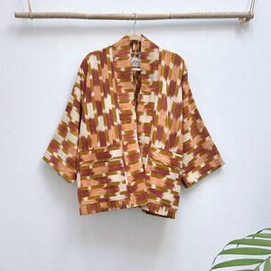 Patterned jacket on a hanger against a white background