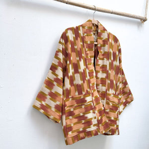 Patterned kimono jacket hanging on a white wall
