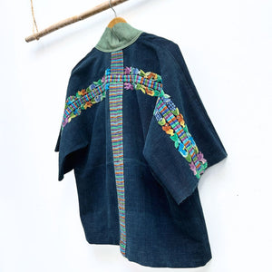 Blue jacket with colorful embroidery on a white background