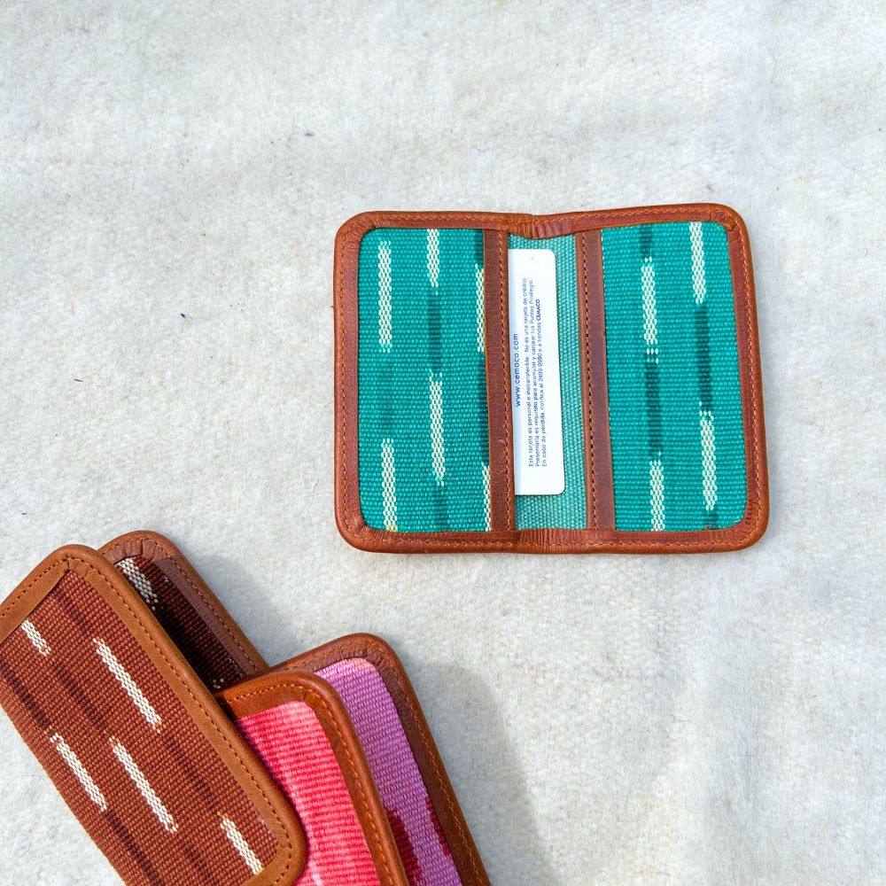 Mint and white fabric cardholder with brown leather border.