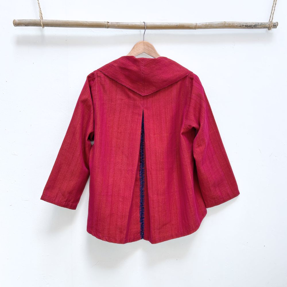 Red garment on a hanger against a white background