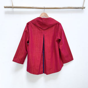 Red garment on a hanger against a white background