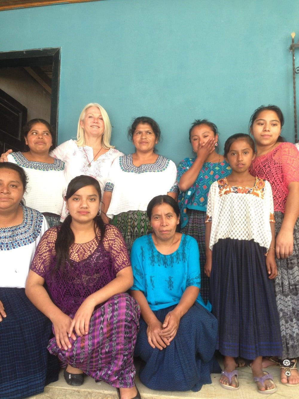 A group image of smiling women in traditional garments