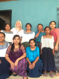 A group image of smiling women in traditional garments