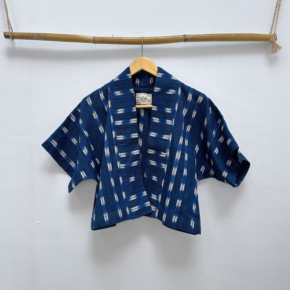Blue patterned shirt on a hanger against a white background