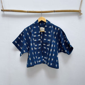 Blue patterned shirt on a hanger against a white background