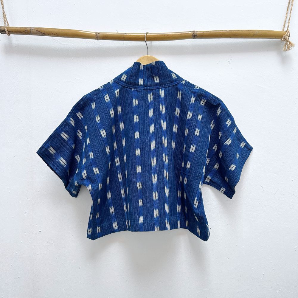 Blue patterned shirt on a hanger against a white background