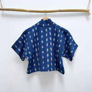Blue patterned shirt on a hanger against a white background